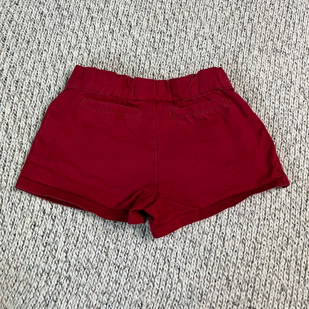 Girls Janie and Jack red shorts with gold buttons.